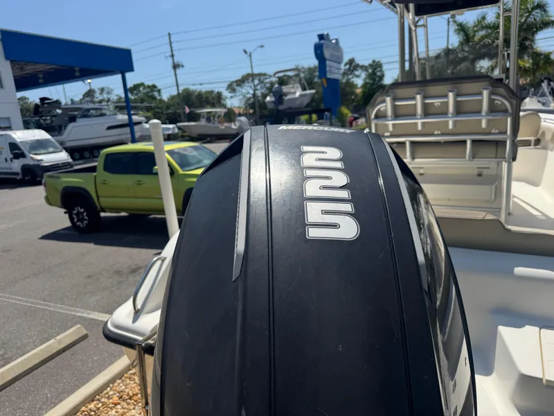 Slide: The Image of 2022 Key West 239 FS boat with powerful outboard motor in a sunny marina. - 8