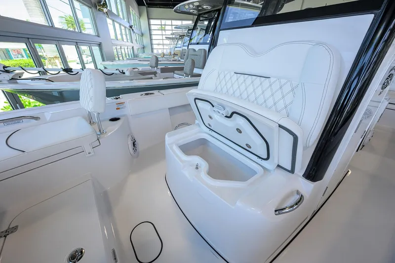 Slide: The Image of 2025 Sportsman Masters 267 Bay Boat interior with white seating and storage compartments. - 10