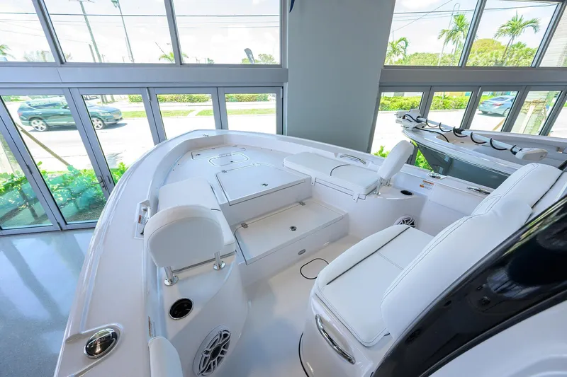 Slide: The Image of 2025 Sportsman Masters 267 Bay Boat interior with white seating and modern design. - 12