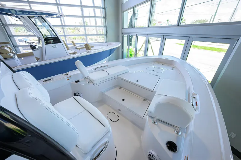 Slide: The Image of 2025 Sportsman Masters 267 Bay Boat interior with white seating and modern design. - 13