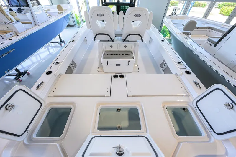 Slide: The Image of 2025 Sportsman Masters 267 Bay Boat interior with seating and storage compartments. - 23
