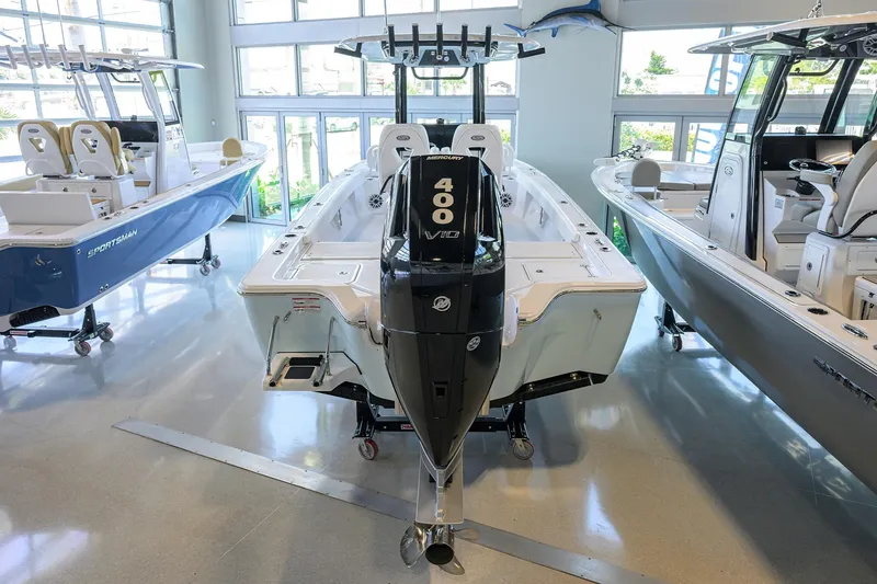 Slide: The Image of 2025 Sportsman Masters 267 Bay Boat with 400 HP engine displayed indoors. - 26