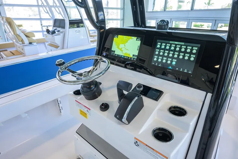 Slide: The Image of 2025 Sportsman Masters 267 Bay Boat dashboard with modern navigation and control systems. - 29