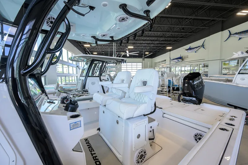 Slide: The Image of 2025 Sportsman Masters 267 Bay Boat interior with white seating and modern design. - 32