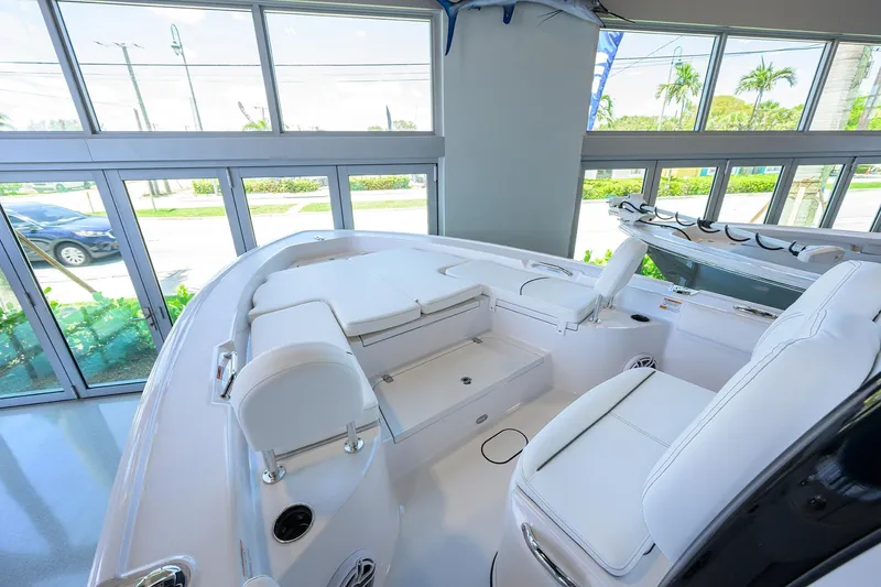 Slide: The Image of 2025 Sportsman Masters 267 Bay Boat interior with white seating in showroom. - 5