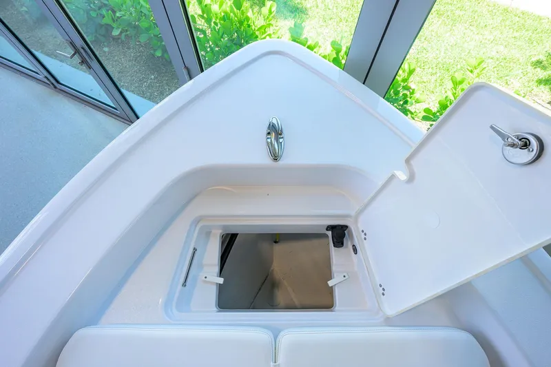 Slide: The Image of 2025 Sportsman Masters 267 Bay Boat storage compartment with open hatch, showcasing sleek design. - 7