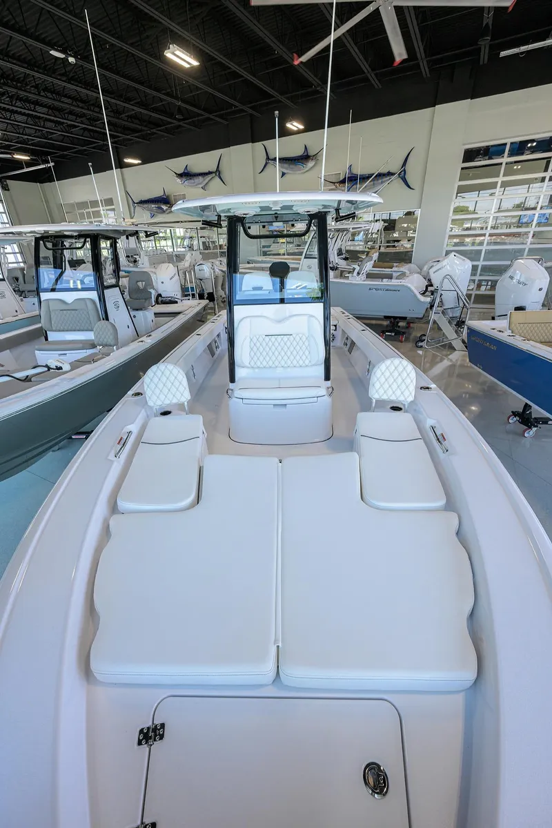 Slide: The Image of 2025 Sportsman Masters 267 Bay Boat in showroom, showcasing spacious deck and seating. - 8