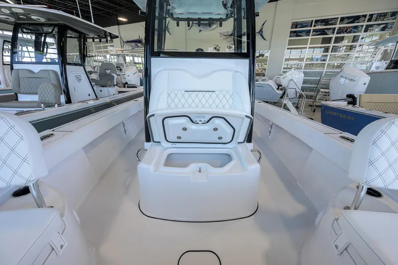 Slide: The Image of 2025 Sportsman Masters 267 Bay Boat interior with open storage compartment. - 9