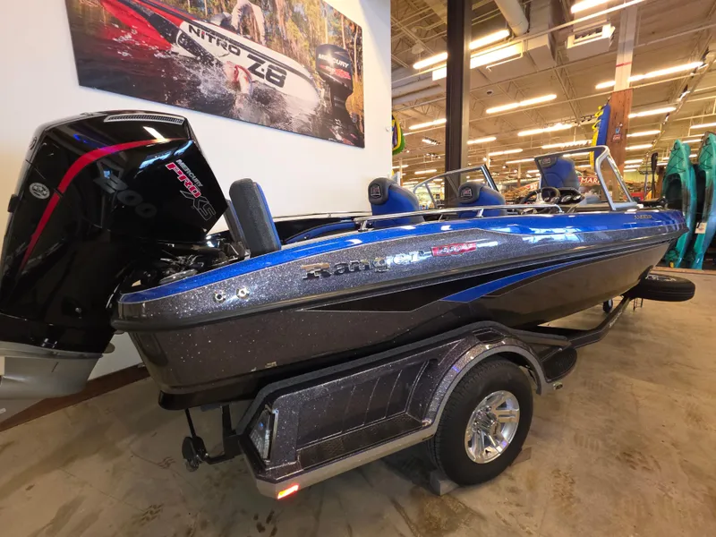 The Image of 2025 Ranger 1880MS boat in showroom, blue and black design, on trailer. - 0