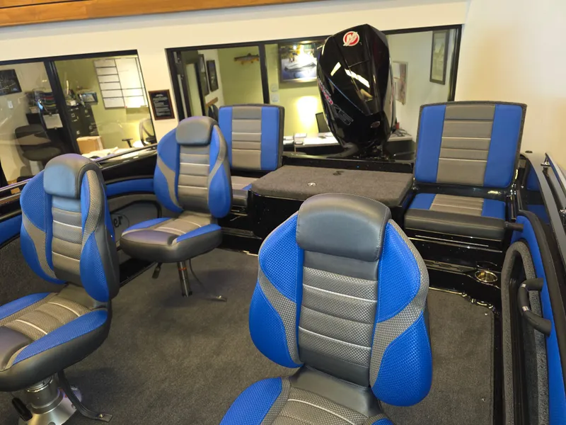 Slide: The Image of 2025 Ranger 1880MS boat interior with blue and gray seating, showcasing modern design and comfort. - 3