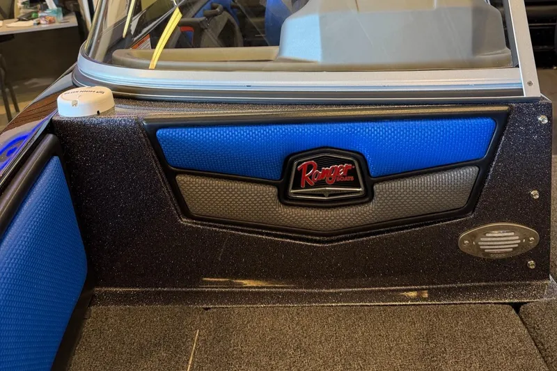 Slide: The Image of Interior view of a 2025 Ranger 1880MS boat, featuring blue and black paneling. - 9