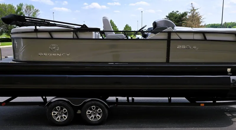 Slide: The Image of 2025 Regency 230 LE3 pontoon boat on a trailer, side view. - 7