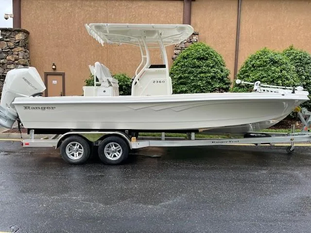 The Image of 2025 Ranger 2360 Bay boat on trailer, parked outdoors. - 0