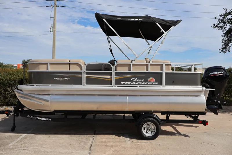 The Image of 2025 Sun Tracker Party Barge 18 DLX pontoon boat with canopy and Mercury engine. - 0