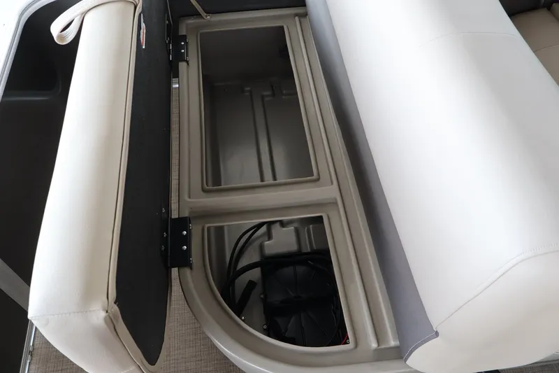 Slide: The Image of An open storage compartment under a seat on a Sun Tracker Party Barge 18 DLX boat. - 32
