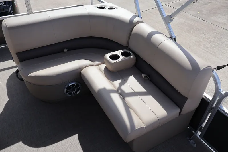 Slide: The Image of 2025 Sun Tracker Party Barge 18 DLX interior seating with cup holders and speaker. - 16
