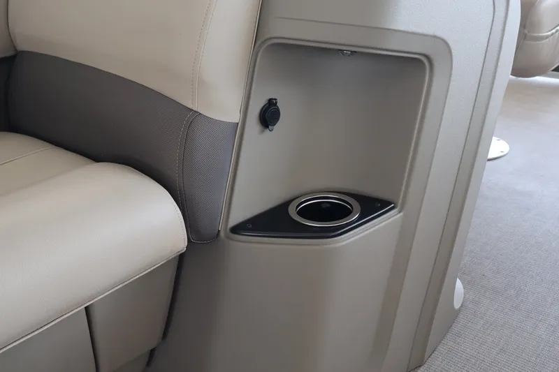 Slide: The Image of 2025 Sun Tracker Party Barge 18 DLX interior with cup holder and seating detail. - 24