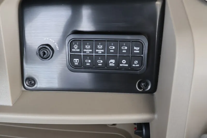 Slide: The Image of Control panel of 2025 Sun Tracker Party Barge 18 DLX with various switches and ignition. - 21