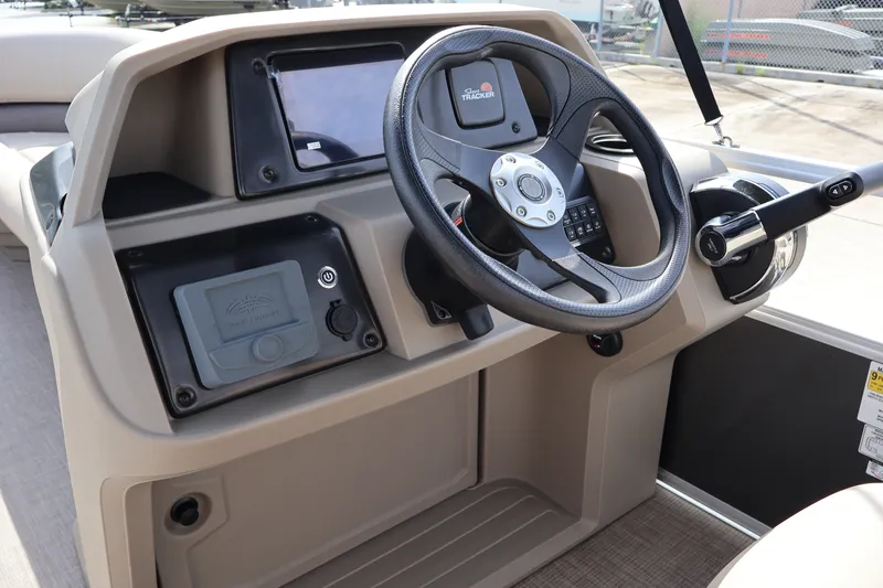 Slide: The Image of 2025 Sun Tracker Party Barge 18 DLX steering console with modern controls and dashboard. - 18