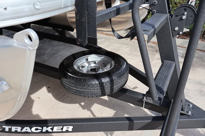 Slide: The Image of 2025 Sun Tracker Party Barge 18 DLX trailer with spare tire and sturdy frame. - 34