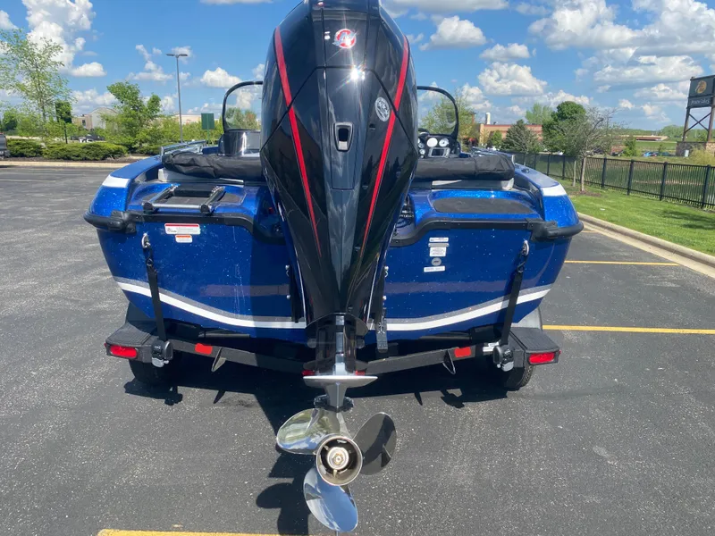 Slide: The Image of 2025 Nitro ZV19 Sport Pro boat with powerful outboard motor, parked outdoors. - 3