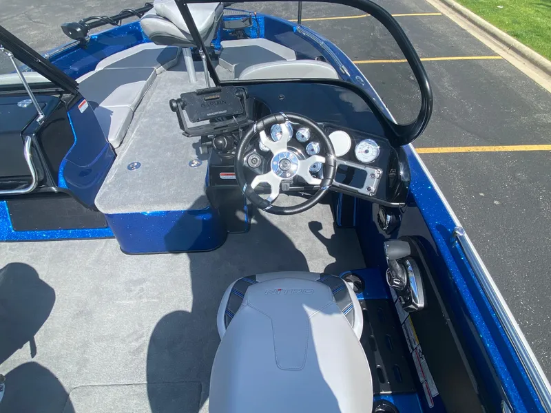 Slide: The Image of 2025 Nitro ZV19 Sport Pro boat interior with steering wheel and Garmin device. - 6