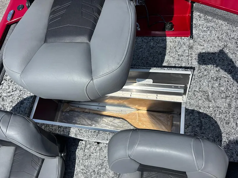 Slide: The Image of 2025 Tracker Pro 170 boat interior with gray seats and open storage compartment. - 20