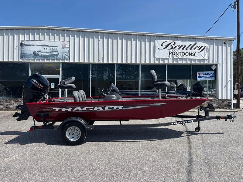 Slide: The Image of 2025 Tracker Pro 170 boat in red, parked outside Bentley Pontoons dealership. - 5