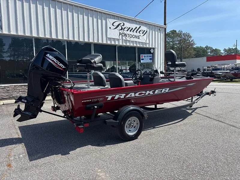 Slide: The Image of 2025 Tracker Pro 170 boat in red, parked outside Bentley Pontoons dealership. - 6