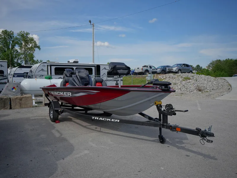 Slide: The Image of 2025 Tracker Pro Team 175 boat on trailer, parked outdoors under clear sky. - 15