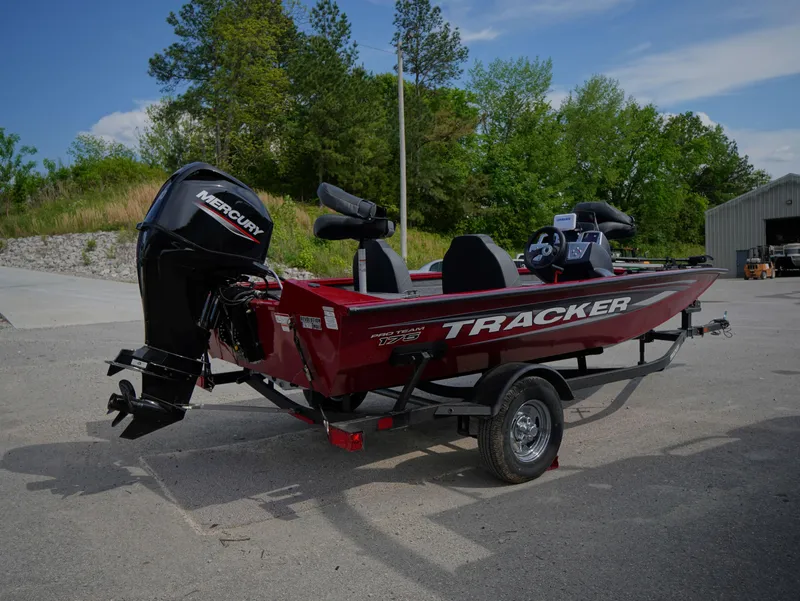 Slide: The Image of 2025 Tracker Pro Team 175 boat with Mercury engine on trailer, parked outdoors. - 5