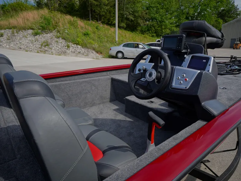 Slide: The Image of 2025 Tracker Pro Team 175 boat interior with steering wheel and seating. - 6