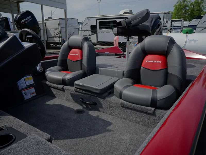 Slide: The Image of 2025 Tracker Pro Team 175 boat interior with two cushioned seats and storage compartment. - 9