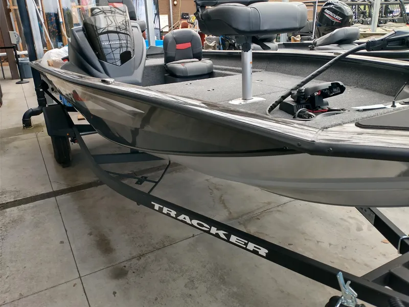 Slide: The Image of 2025 Tracker Pro Team 175 Crappie Edition boat interior with steering console and seating. - 2