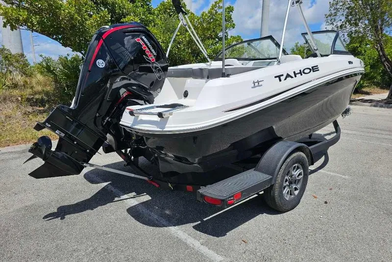 Slide: The Image of 2025 Tahoe 185 S boat on trailer, featuring a powerful outboard motor. - 3