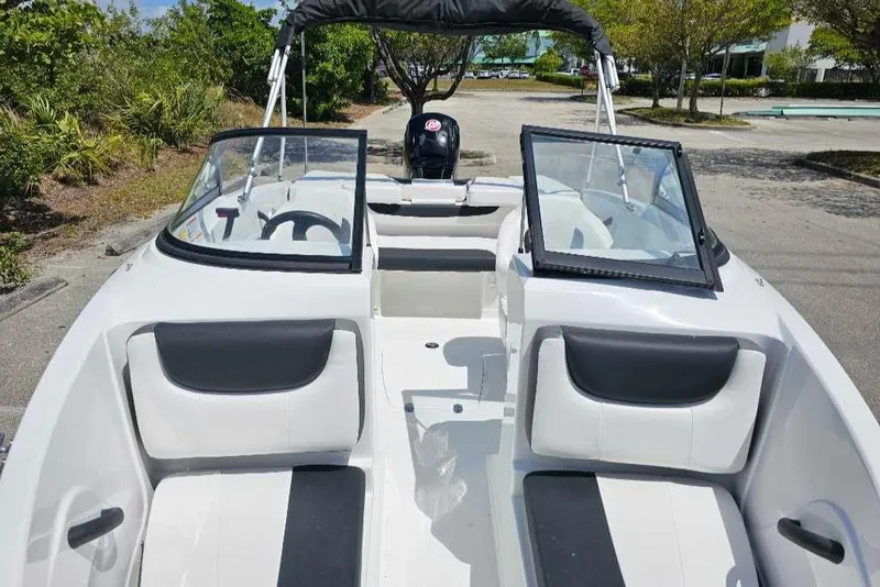 Slide: The Image of 2025 Tahoe 185 S boat interior with open windshield, black and white seating, and steering wheel. - 5