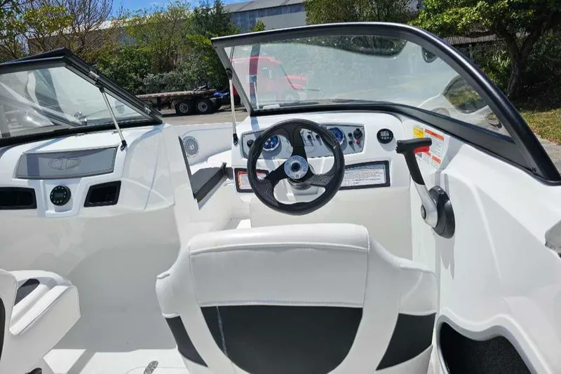 Slide: The Image of 2025 Tahoe 185 S boat interior with steering wheel and dashboard controls. - 6