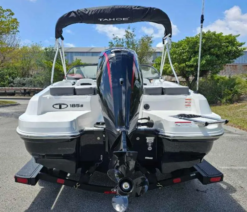 Slide: The Image of 2025 Tahoe 185 S boat, rear view, parked outdoors on a sunny day. - 8