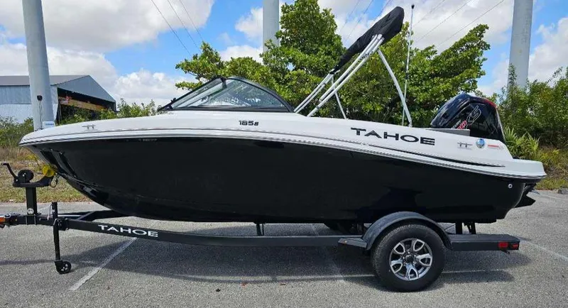 Slide: The Image of 2025 Tahoe 185 S boat on trailer, black and white design, parked outdoors. - 92