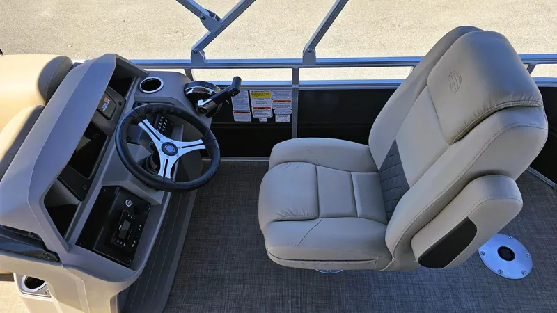 Slide: The Image of 2025 Sun Tracker Fishin' Barge 20 DLX helm with steering wheel and captain's chair. - 8