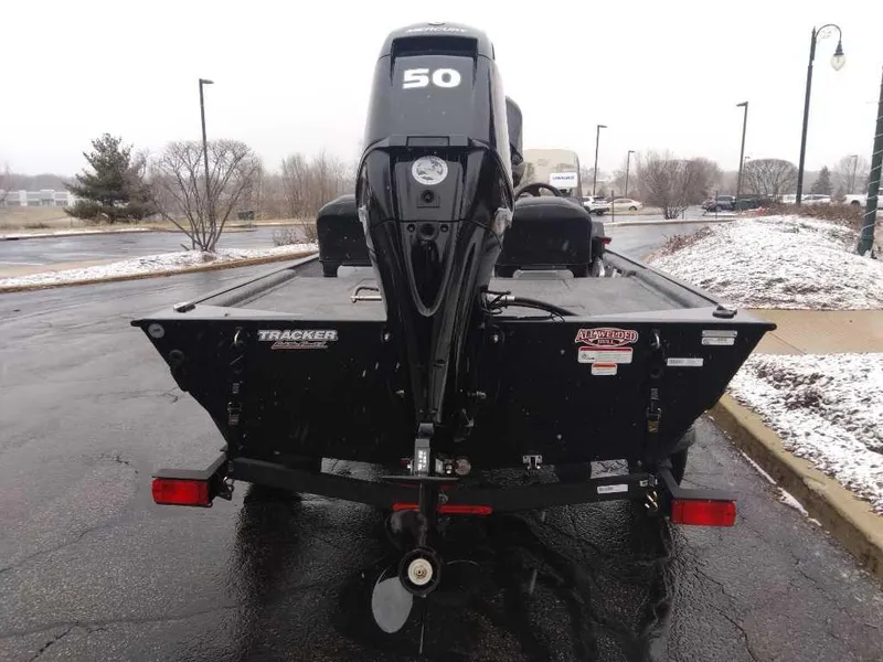 Slide: The Image of 2025 Tracker Bass Tracker Classic XL boat with 50 HP motor, parked on a snowy day. - 3