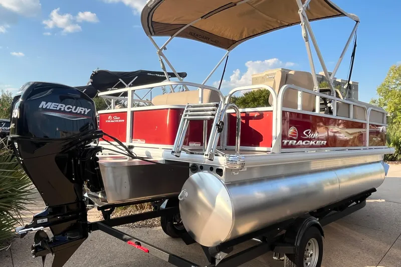 Slide: The Image of 2025 Sun Tracker Party Barge 18 DLX pontoon boat with Mercury outboard motor. - 2