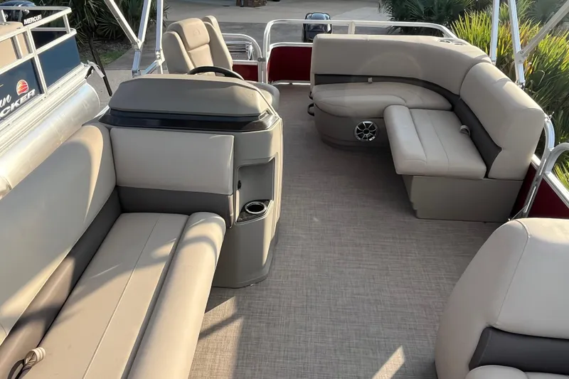 Slide: The Image of 2025 Sun Tracker Party Barge 18 DLX interior with beige seating and spacious layout. - 3
