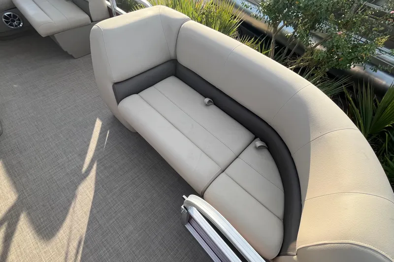 Slide: The Image of 2025 Sun Tracker Party Barge 18 DLX pontoon boat seating area with beige upholstery. - 4
