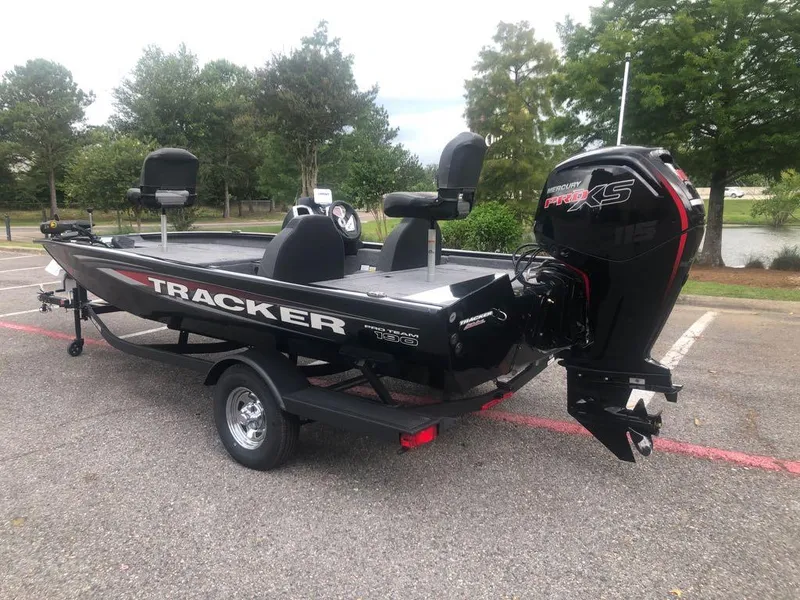 Slide: The Image of 2025 Tracker Pro Team 190 boat with Mercury engine, parked outdoors. - 1