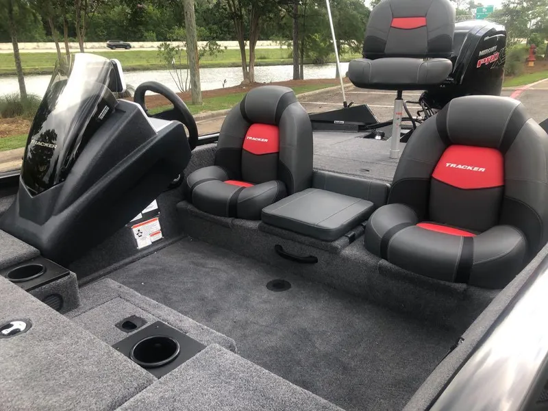 Slide: The Image of 2025 Tracker Pro Team 190 boat interior with gray and red seating. - 10
