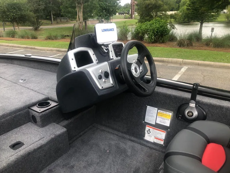Slide: The Image of 2025 Tracker Pro Team 190 boat interior with steering wheel and Lowrance navigation system. - 11