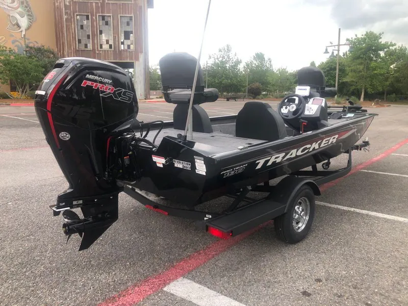 Slide: The Image of 2025 Tracker Pro Team 190 boat with Mercury engine in a parking lot. - 4