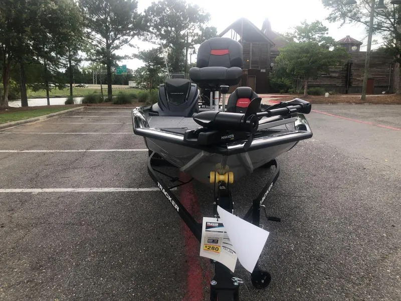 Slide: The Image of 2025 Tracker Pro Team 190 boat parked in a lot, front view. - 7