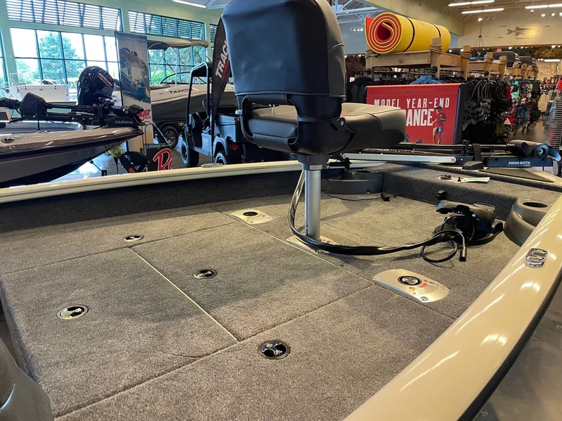 Slide: The Image of 2025 Tracker Pro Team 175 Crappie Edition boat interior with fishing seat and carpeted deck. - 3